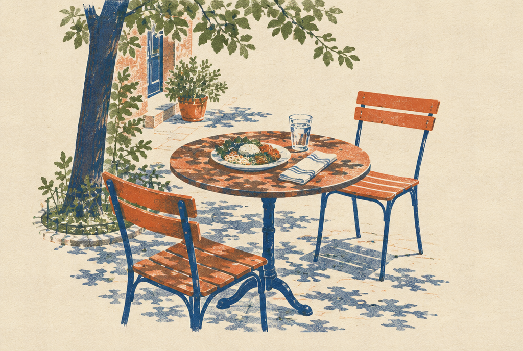 A cafe table set for one under a street tree